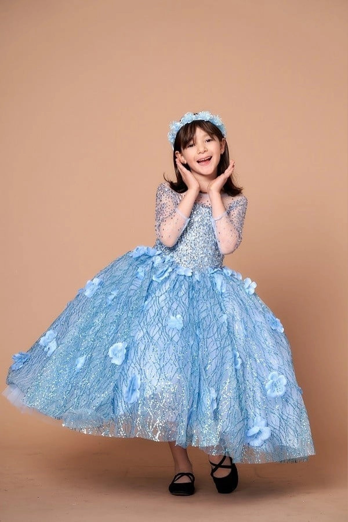 Seen at full length, the Bahama Blue mini quince dress showcases sheer long sleeves with glitter lace embroidery and full textured formal ball gown skirt.
