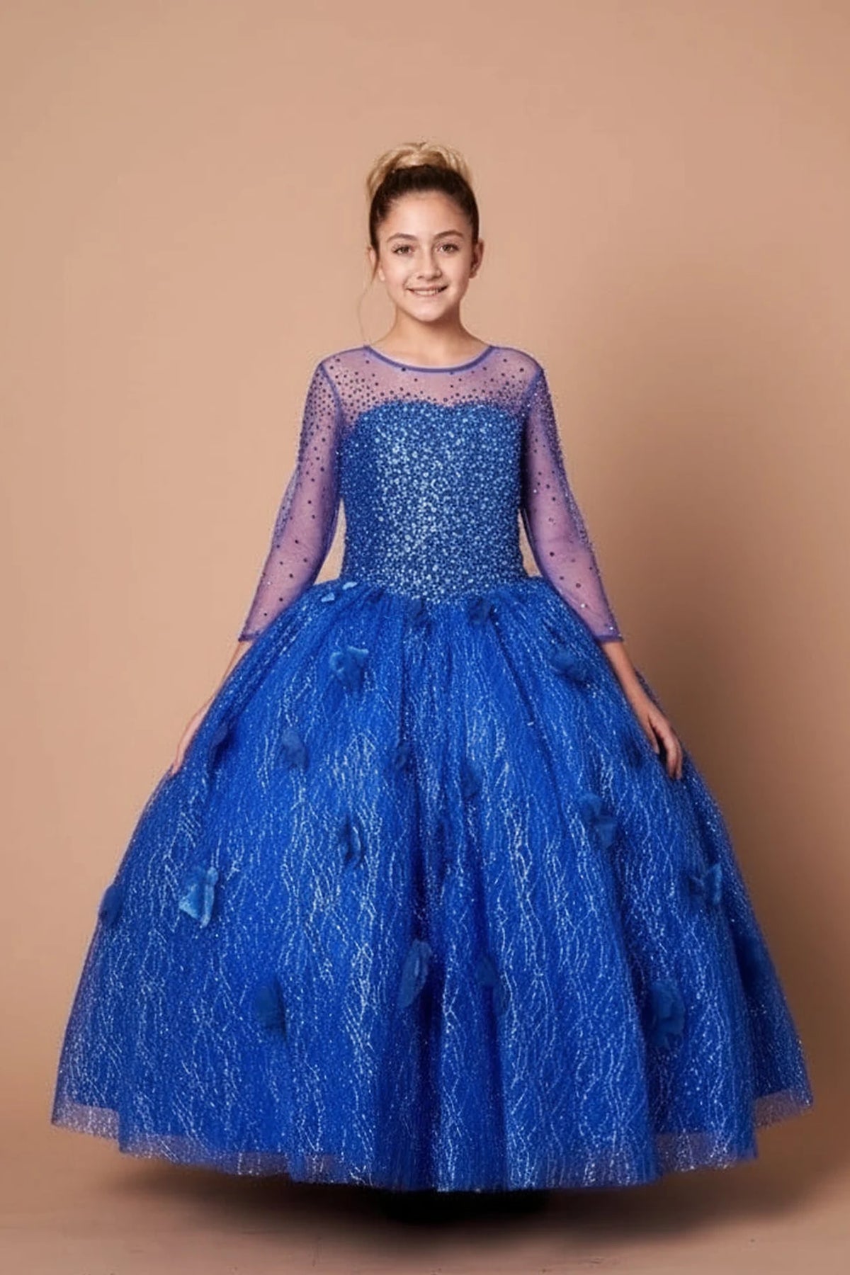 From the neckline down, the Royal Blue mini quince dress showcases sheer long sleeves with glitter lace embroidery and full textured formal ball gown skirt.