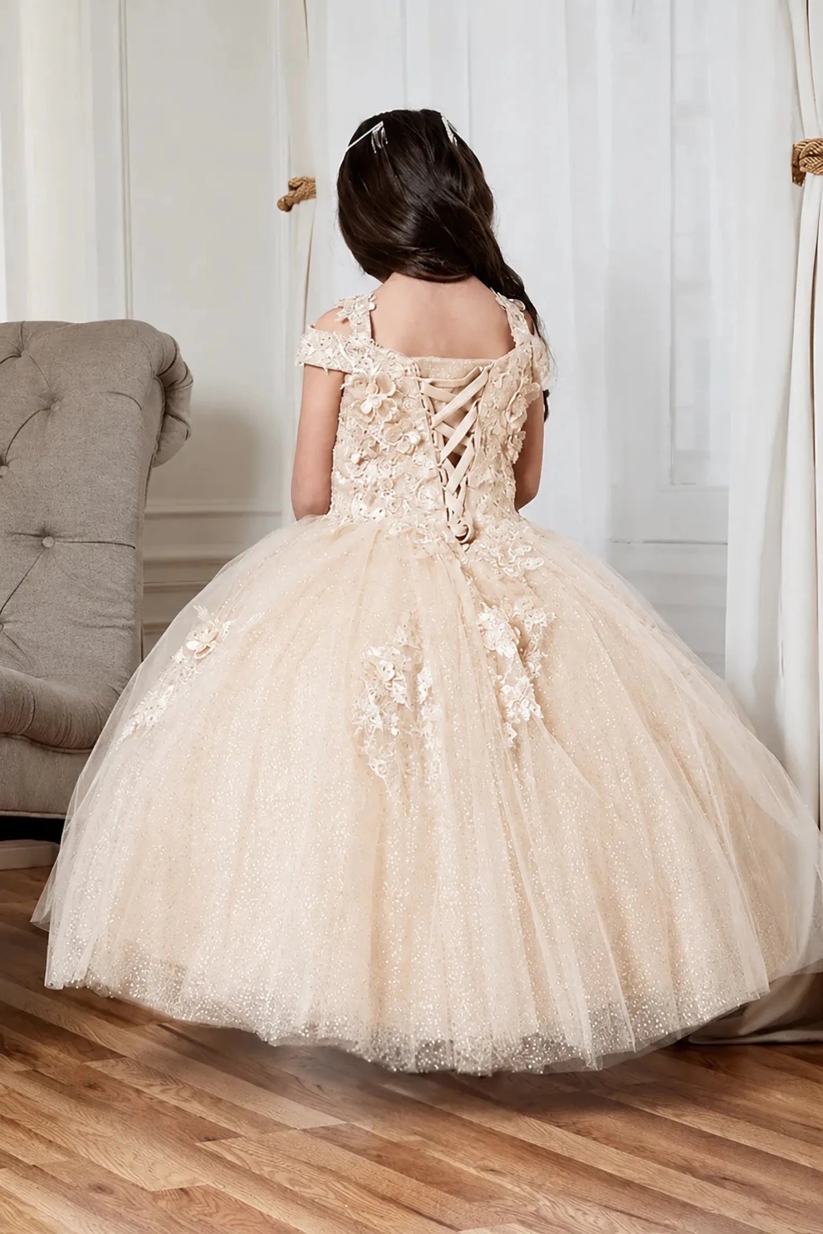 champagne tulle mini quince dress with floral lace appliques and an off-the-shoulder lace-up back.