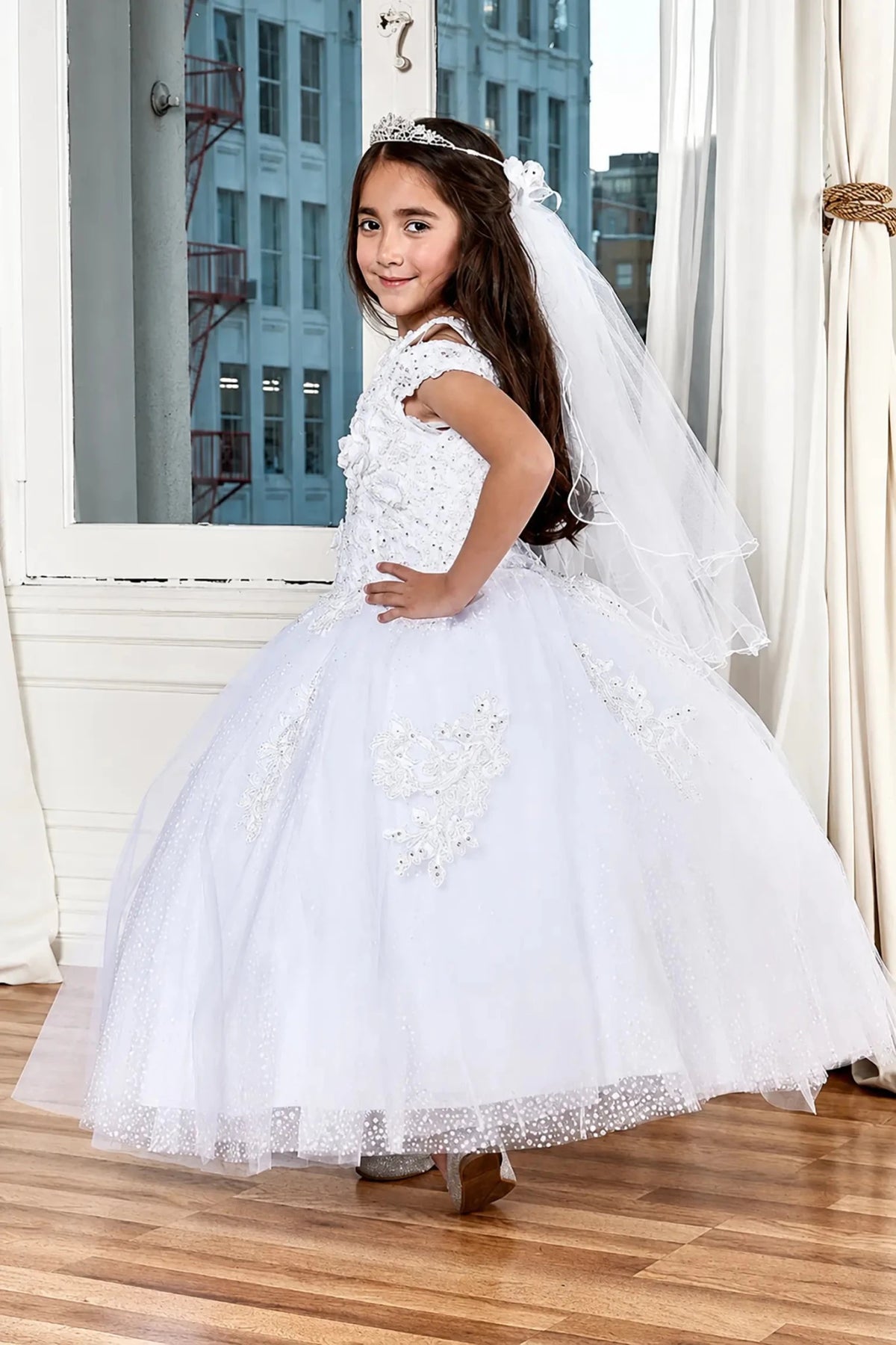 A white pageant mini quince dress with a full tulle skirt, lace bodice.