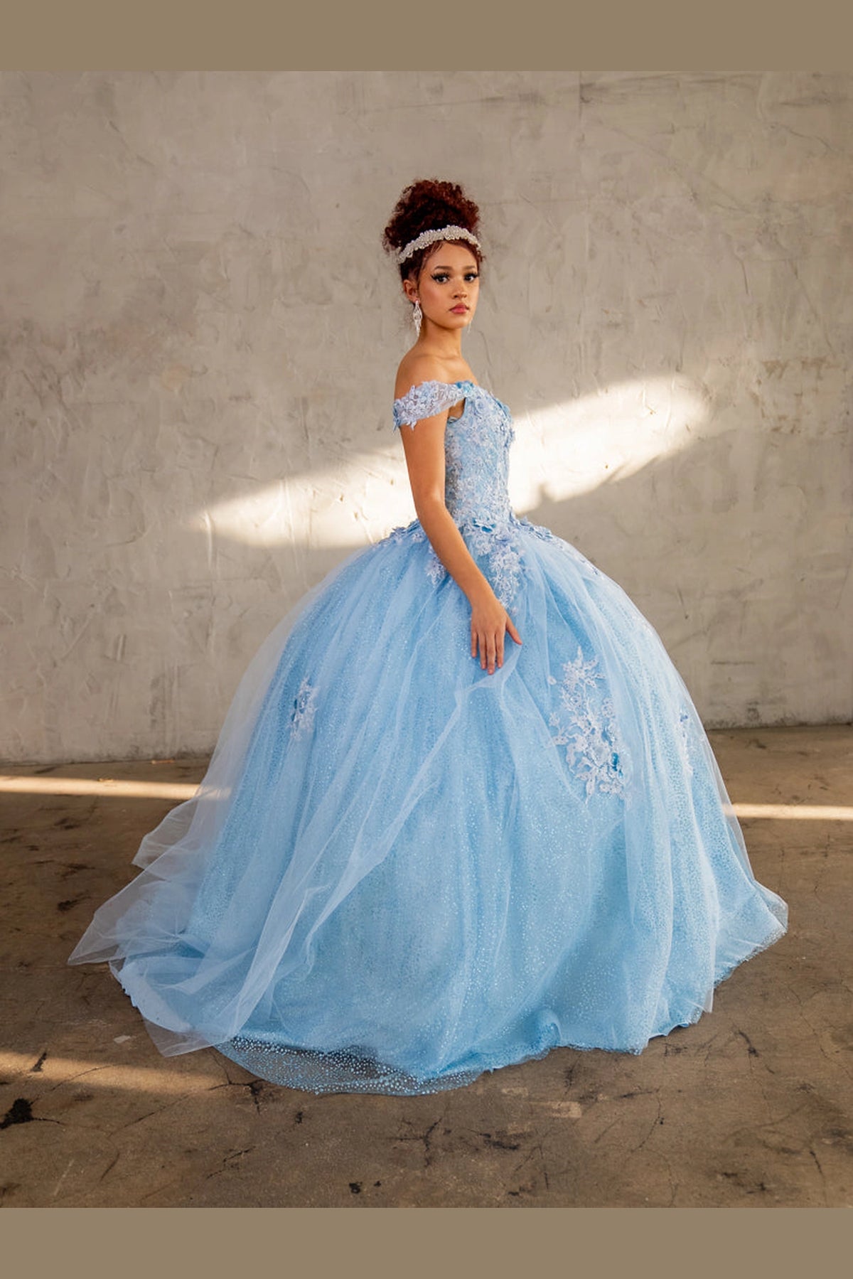 Across this Bahama Blue quinceañera ball gown, the image highlights full tulle ball gown skirt from an alternate angle.