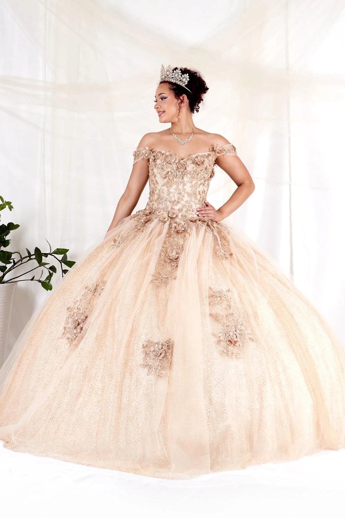 Across this Champagne quinceañera ball gown, the image highlights full tulle ball gown skirt from an alternate angle.