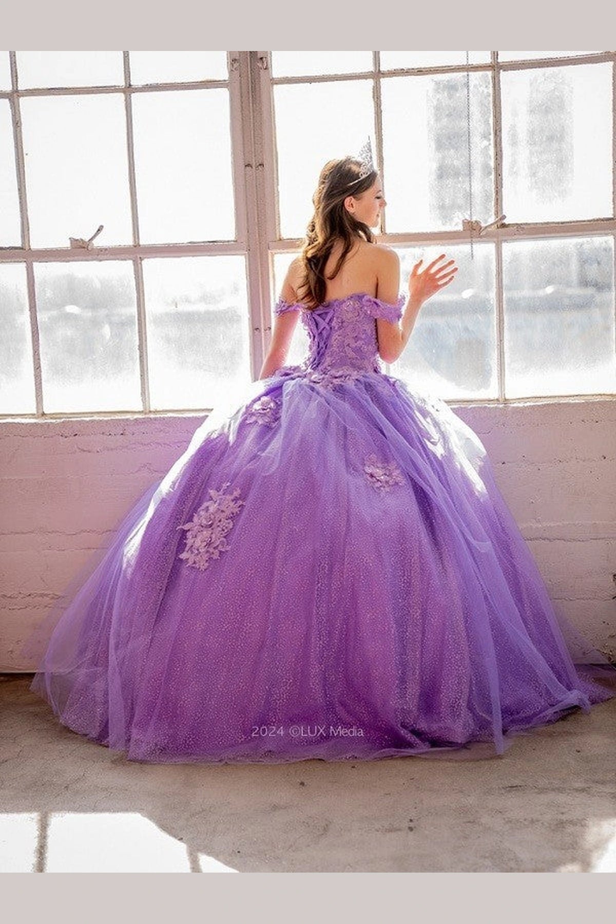 Across this Lilac quinceañera ball gown, the image highlights full tulle ball gown skirt from an alternate angle.