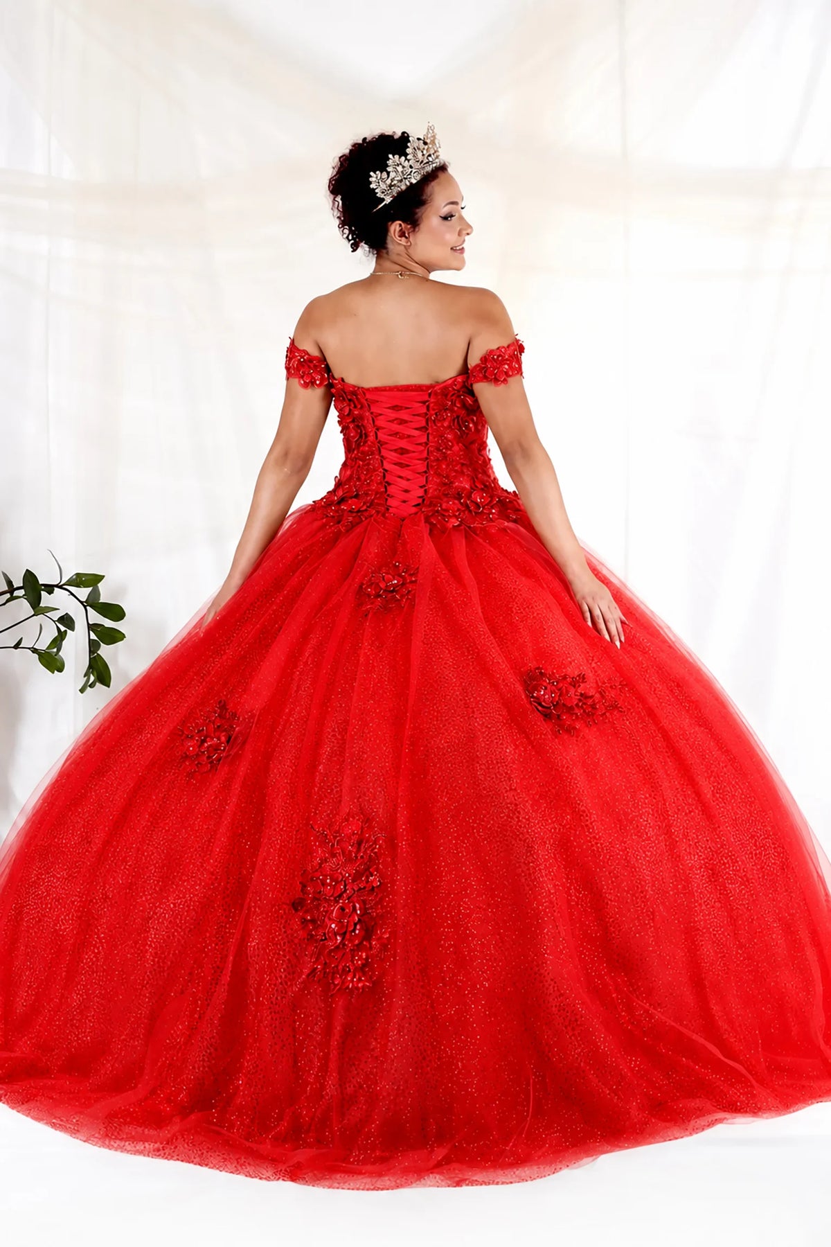 From behind, the Red quinceañera ball gown reveals a shaped lace-up back and the sweep of the full skirt.