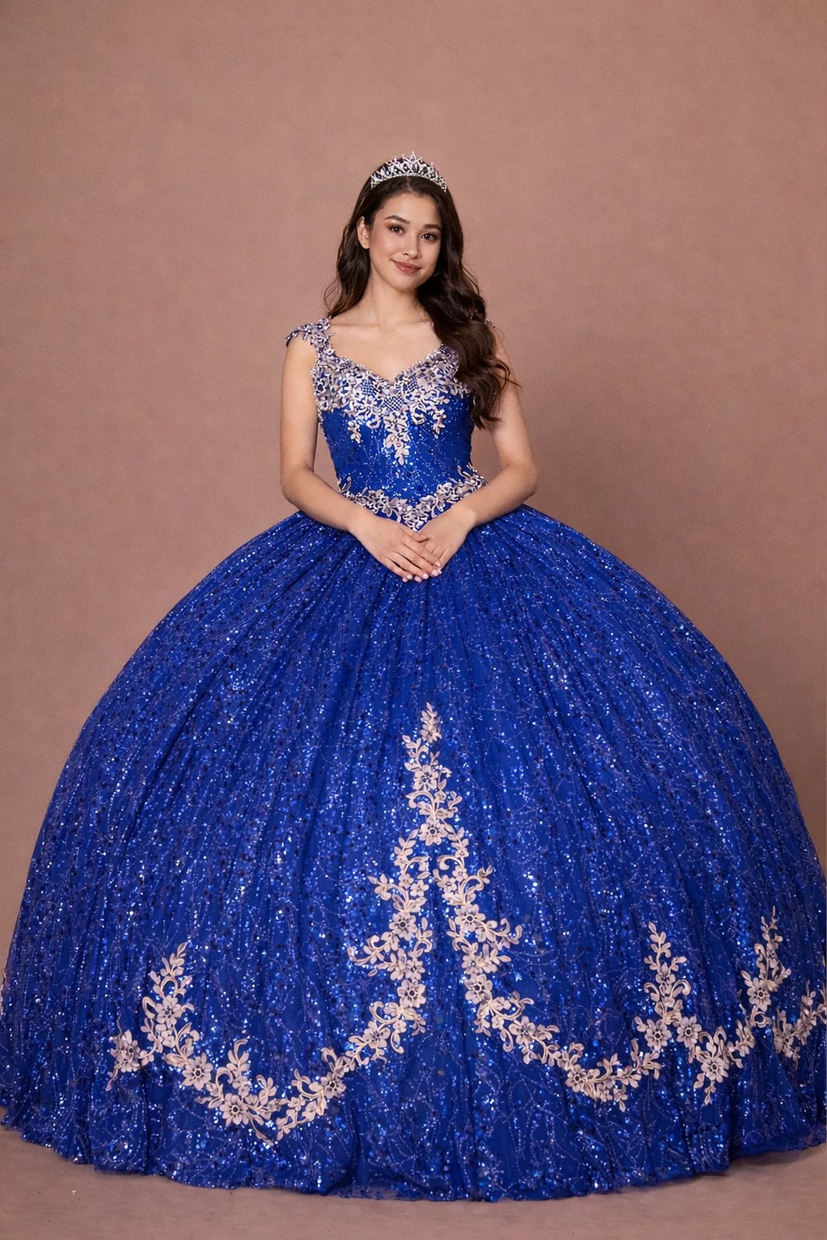 Royal Blue Gold quinceañera dress showcases metallic embroidered scrollwork above sparkling full ball gown silhouette.