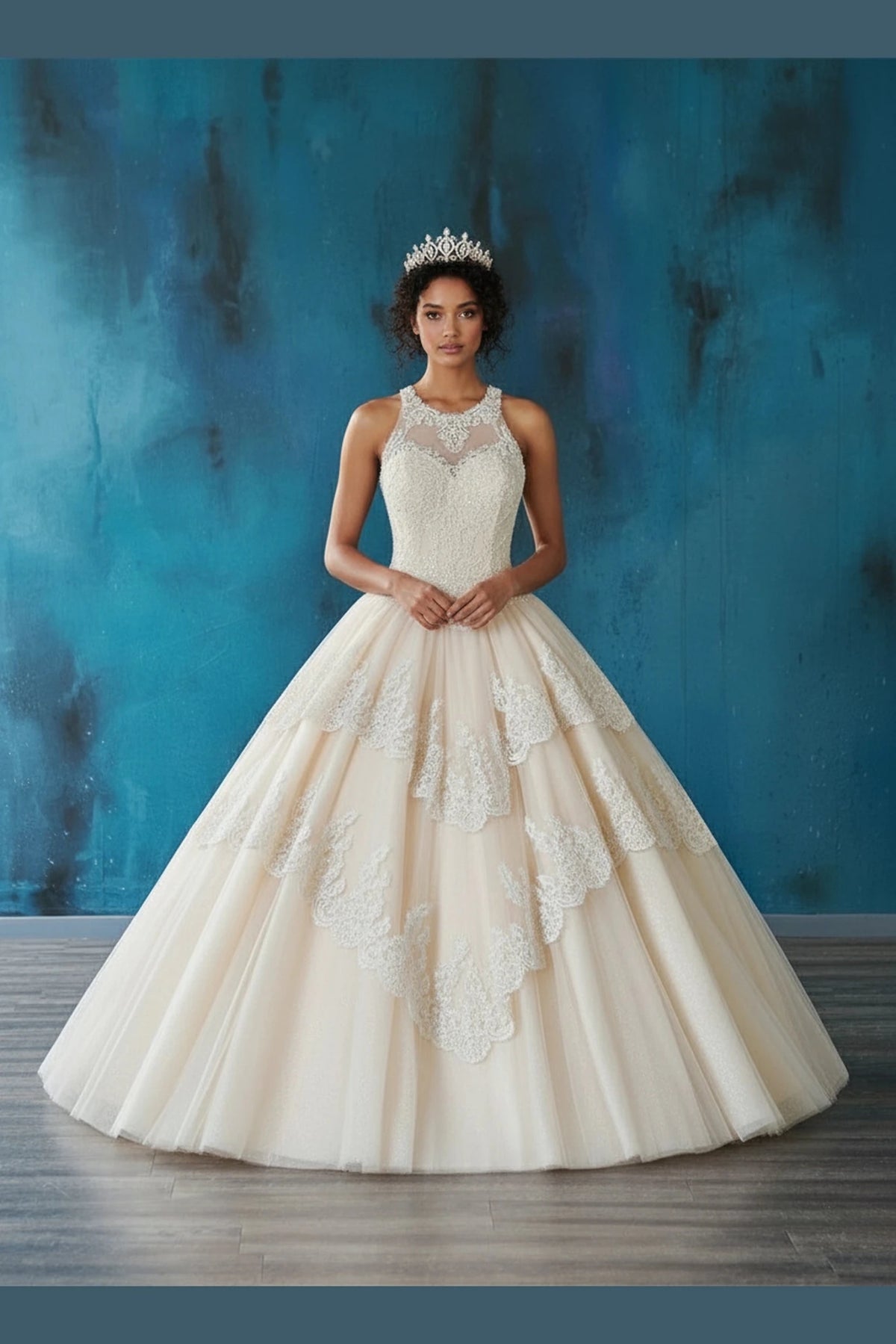 A smooth layered skirt frames the Champagne quinceañera dress beneath its jewel neckline and appliqué panels.