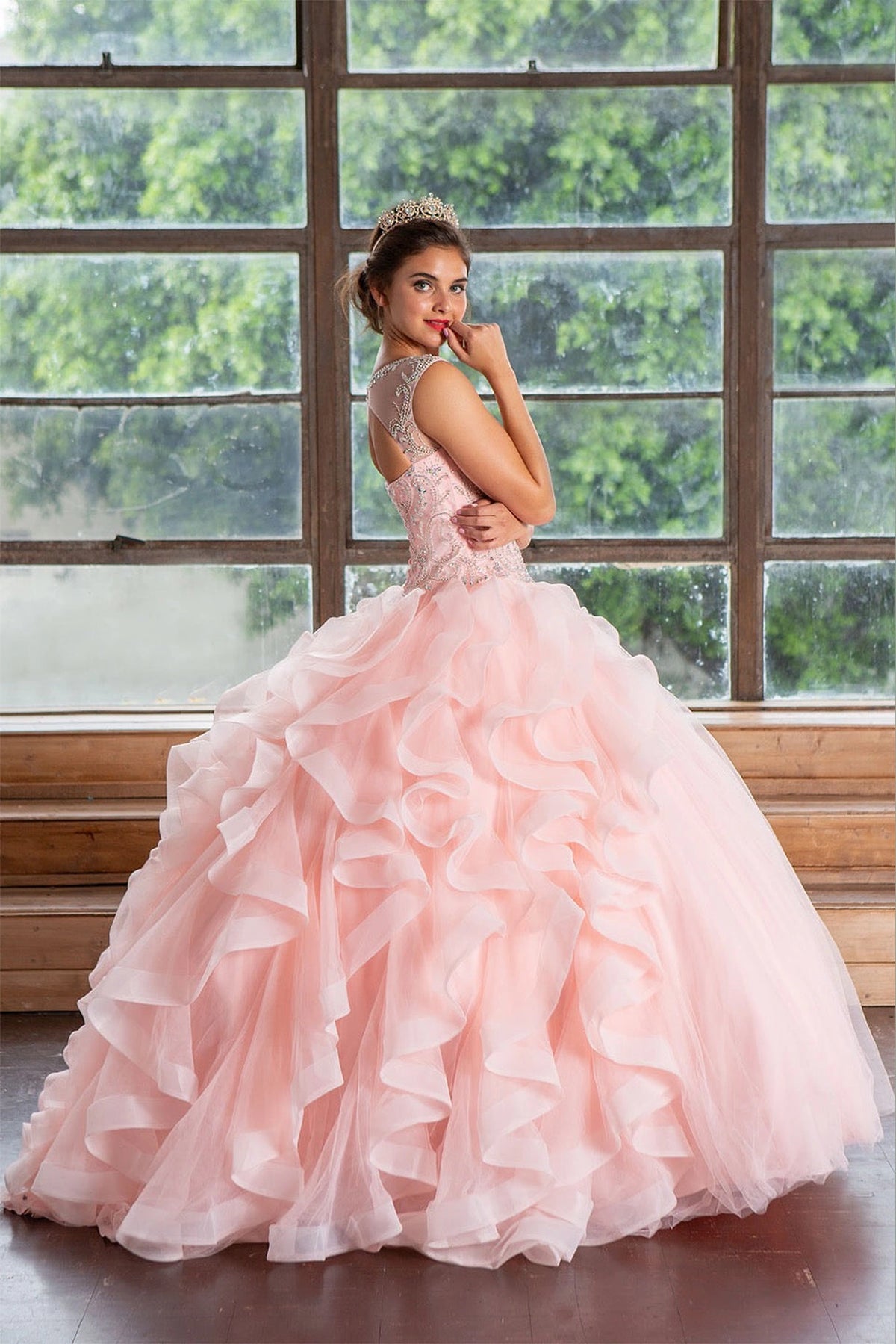 From behind, the Blush Pink quinceañera ball gown reveals embellished fitted bodice from an alternate angle.