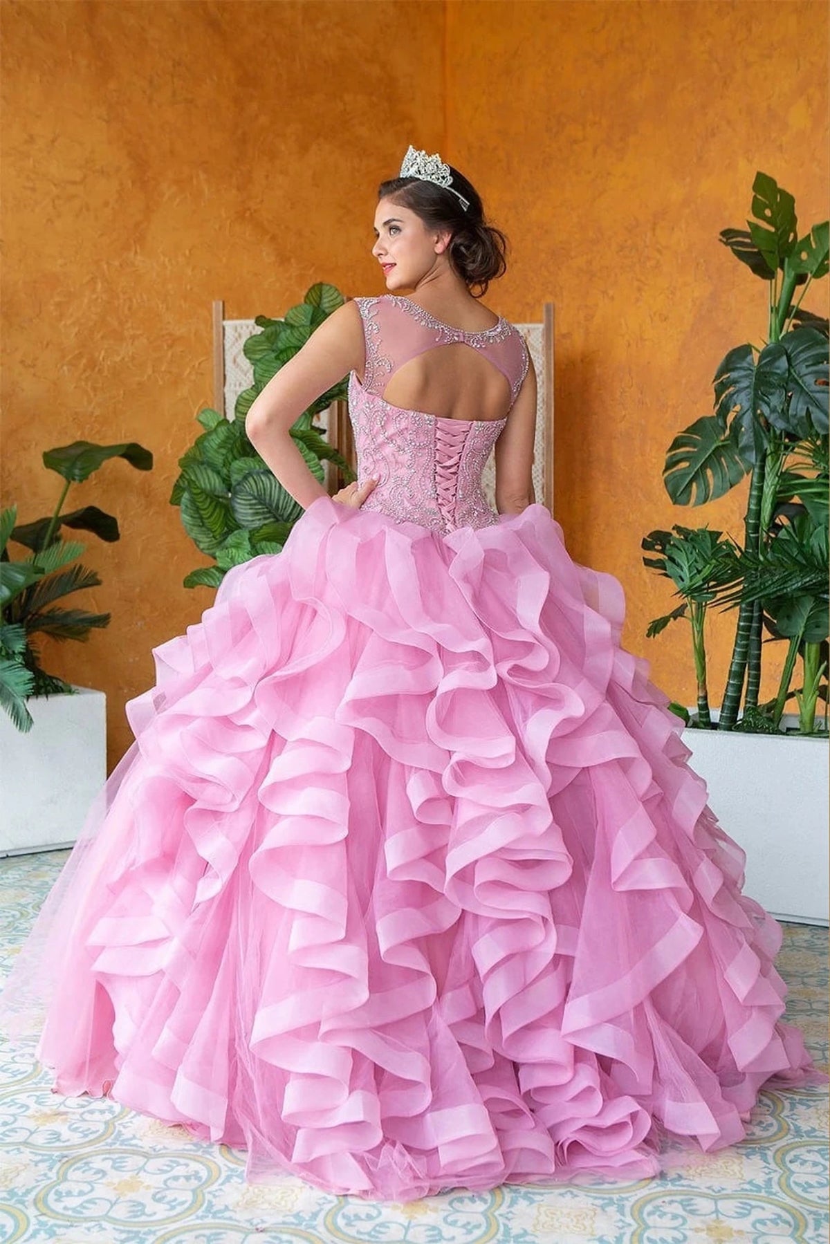 Mauve quinceañera dress showcases cascading dimensional ruffle skirt above embellished fitted bodice.