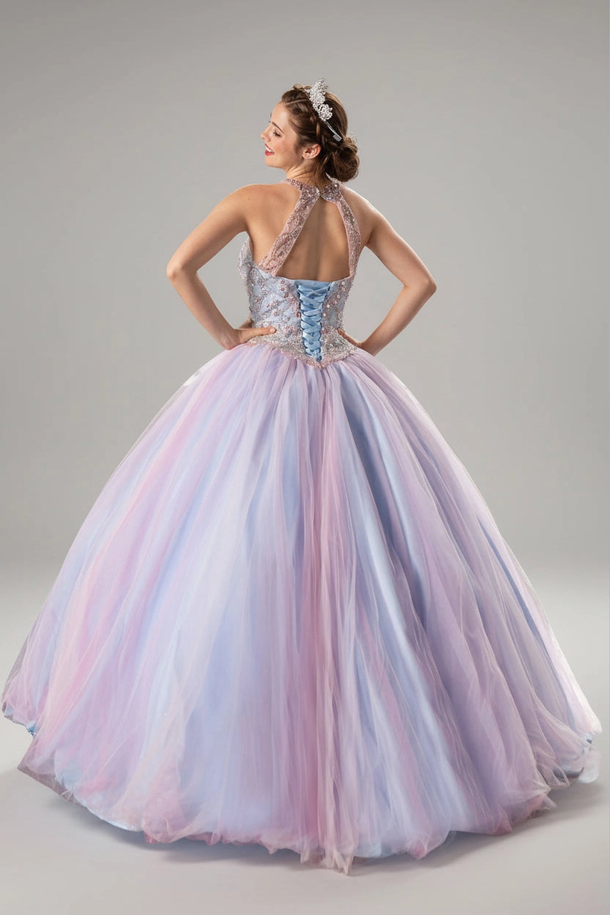 From behind, the Blush Blue quinceañera ball gown reveals a shaped lace-up back and the sweep of the full skirt.