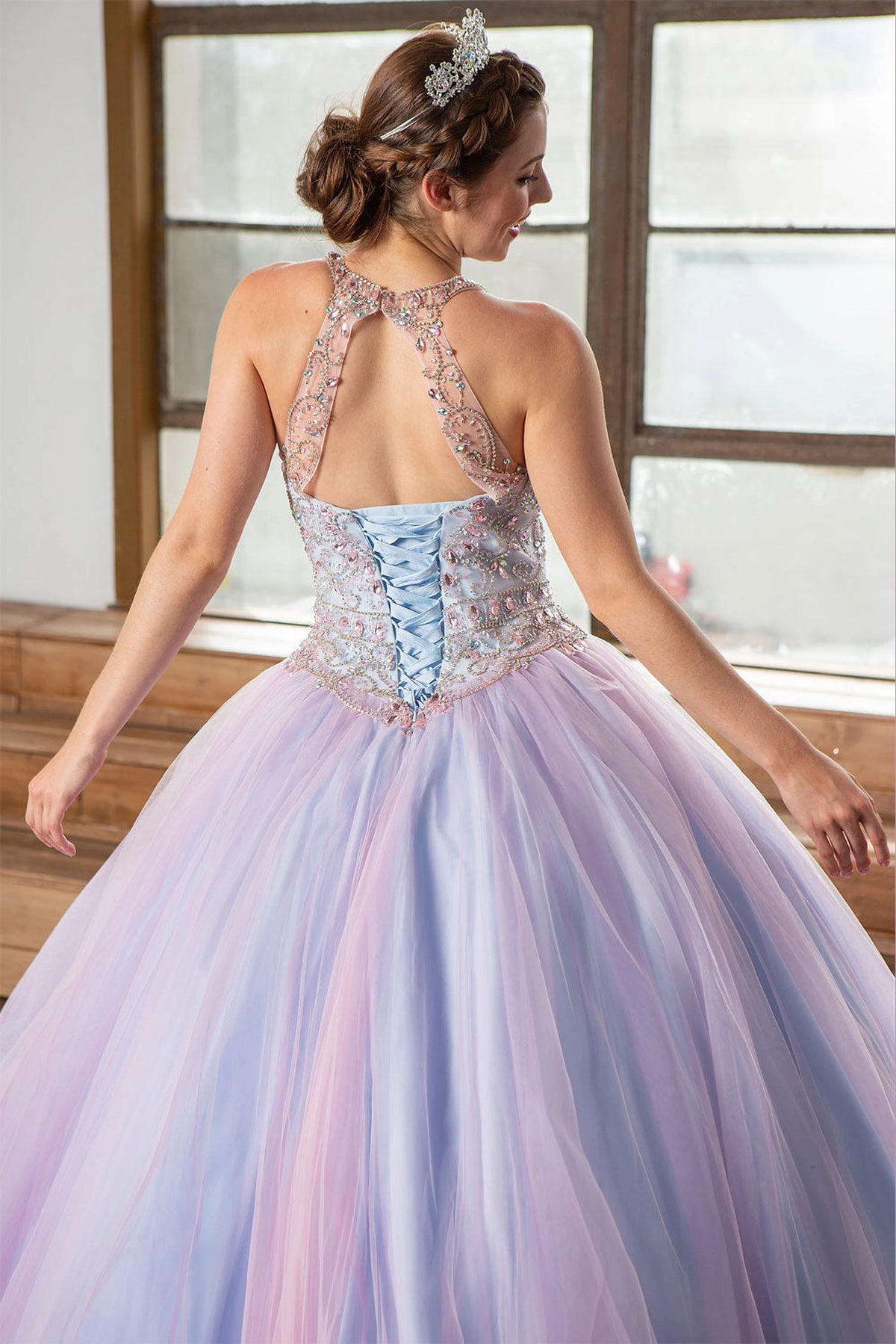 An embroidered halter back and lace-up waist shape the Blush Blue quinceañera dress above its two-tone skirt.