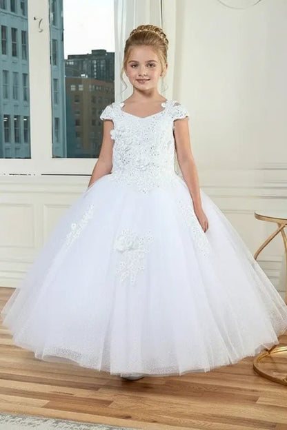 Kid standing front-facing in elegant white mini quince dress with shiny tulle bodice and voluminous full skirt