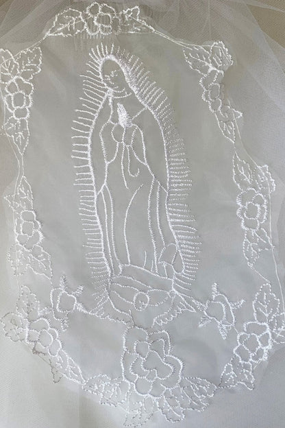 Textured details appear across white lace Virgin Mary embroidered first communion lace applique.