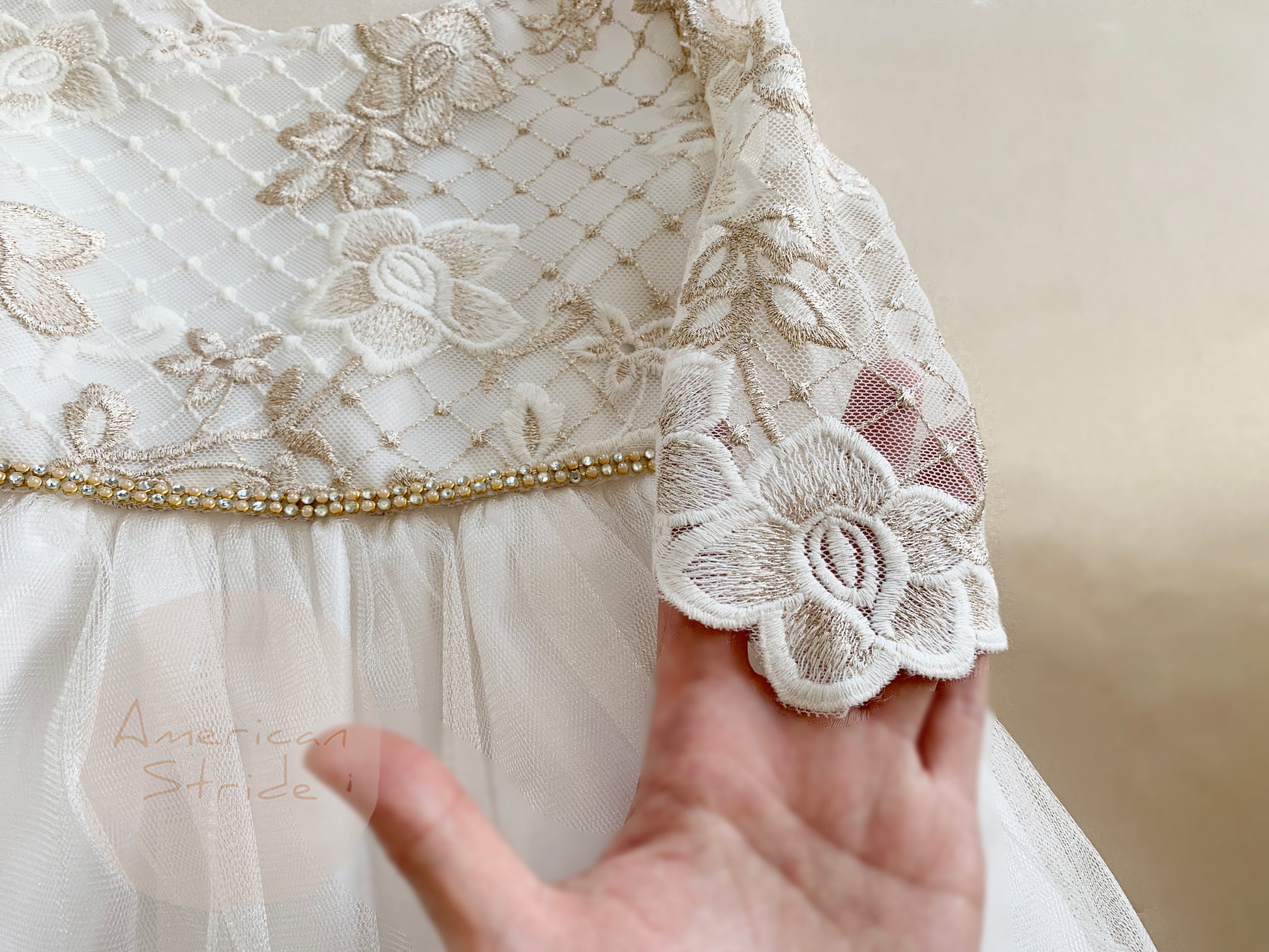 Off-White USA Made | 3/4 sleeve Lattice Flower Embroidered Lace with Satin & Crystal Tulle Flower Girl Dress - zoomed in view with hand holding sleeve