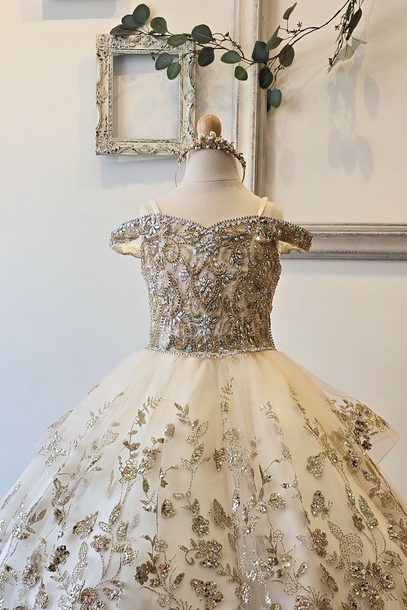 Front zoom view of an ivory champagne kids mini quinceanera mini quince dress with gem-embellished bodice, glitter tulle skirt, and detachable train.
