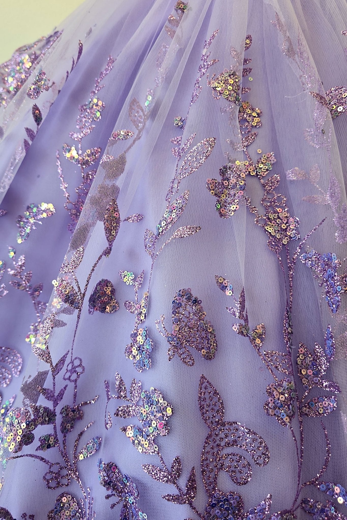 Skirt detail of a lilac kids mini quinceanera mini quince dress with layered glitter tulle fabric and detachable long train.