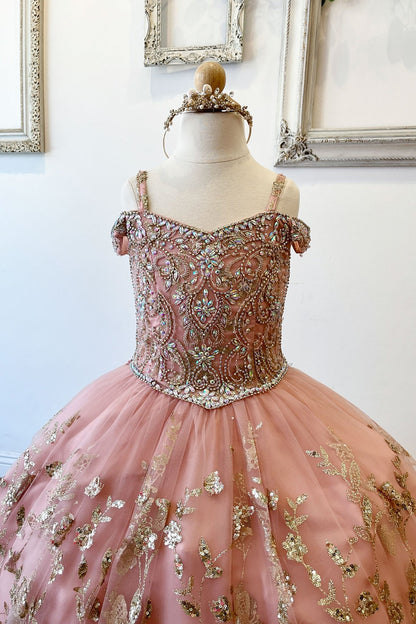 Half front view of a rose gold kids mini quinceanera dress highlighting gem-embellished bodice, floral detailing, and glitter tulle skirt