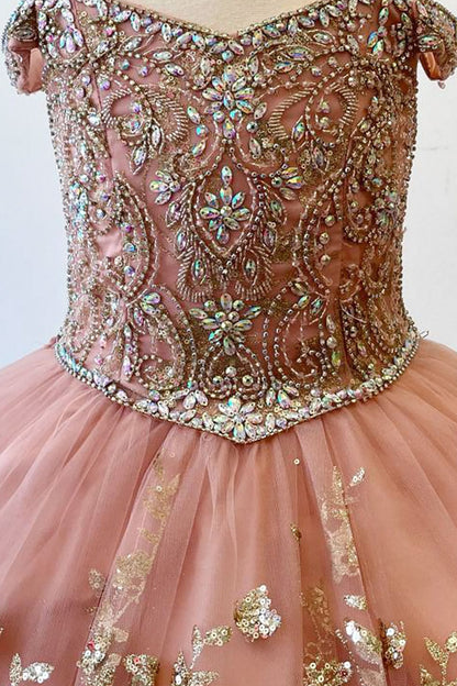 Zoomed front view of a rose gold kids mini quinceanera dress highlighting gem-embellished bodice, floral detailing, and glitter tulle skirt