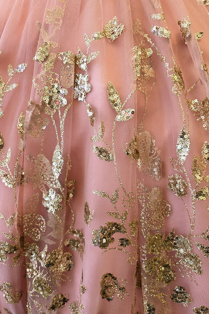 Skirt detail of a rose gold kids mini quinceanera dress with layered glitter tulle fabric and detachable long train