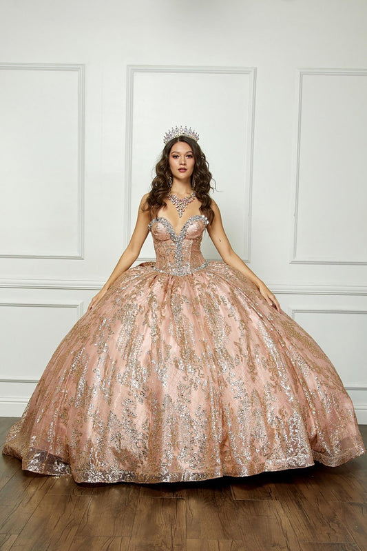 Woman in a sparkling gold quinceanera ball gown against a white paneled wall.