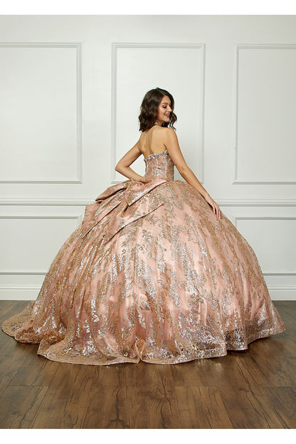 Champagne Quinceanera | Spackly Sequins and Embellishments See-through Corset Bodice adorned with Shimmering Gems Quince Ballgown - back view of woman wearing dress and smiling