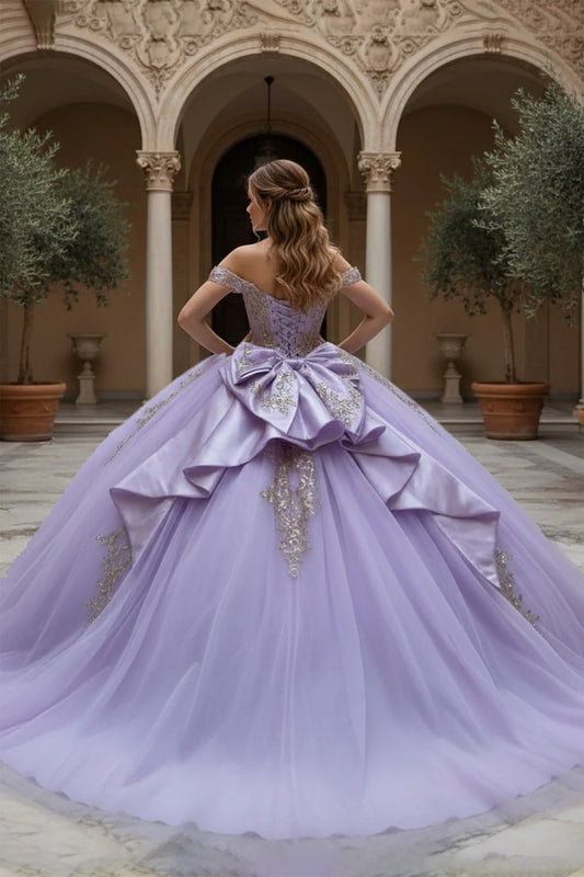 Woman in a lavender quince ball gown with beautiful back bow and gold embroidery 
