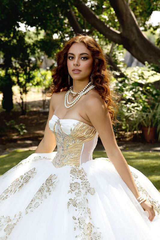 close up the white and gold embroidery quince ball gown dress with a scenic background