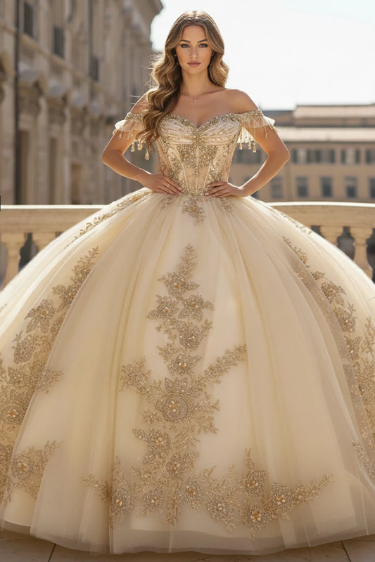 Woman wearing a gold embroidered  white quince ball gown in an urban setting.