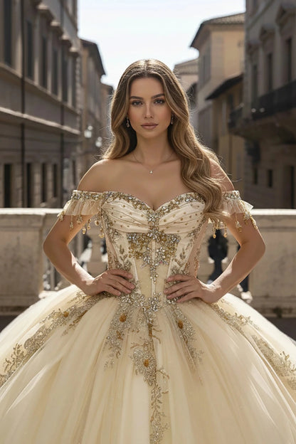 Girl in an ornate off-shoulder champagne dress with bead appliques and embroidery standing in an urban setting