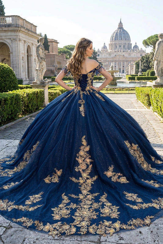Woman in a navy quinceanera ball gown with gold embroidery and long train