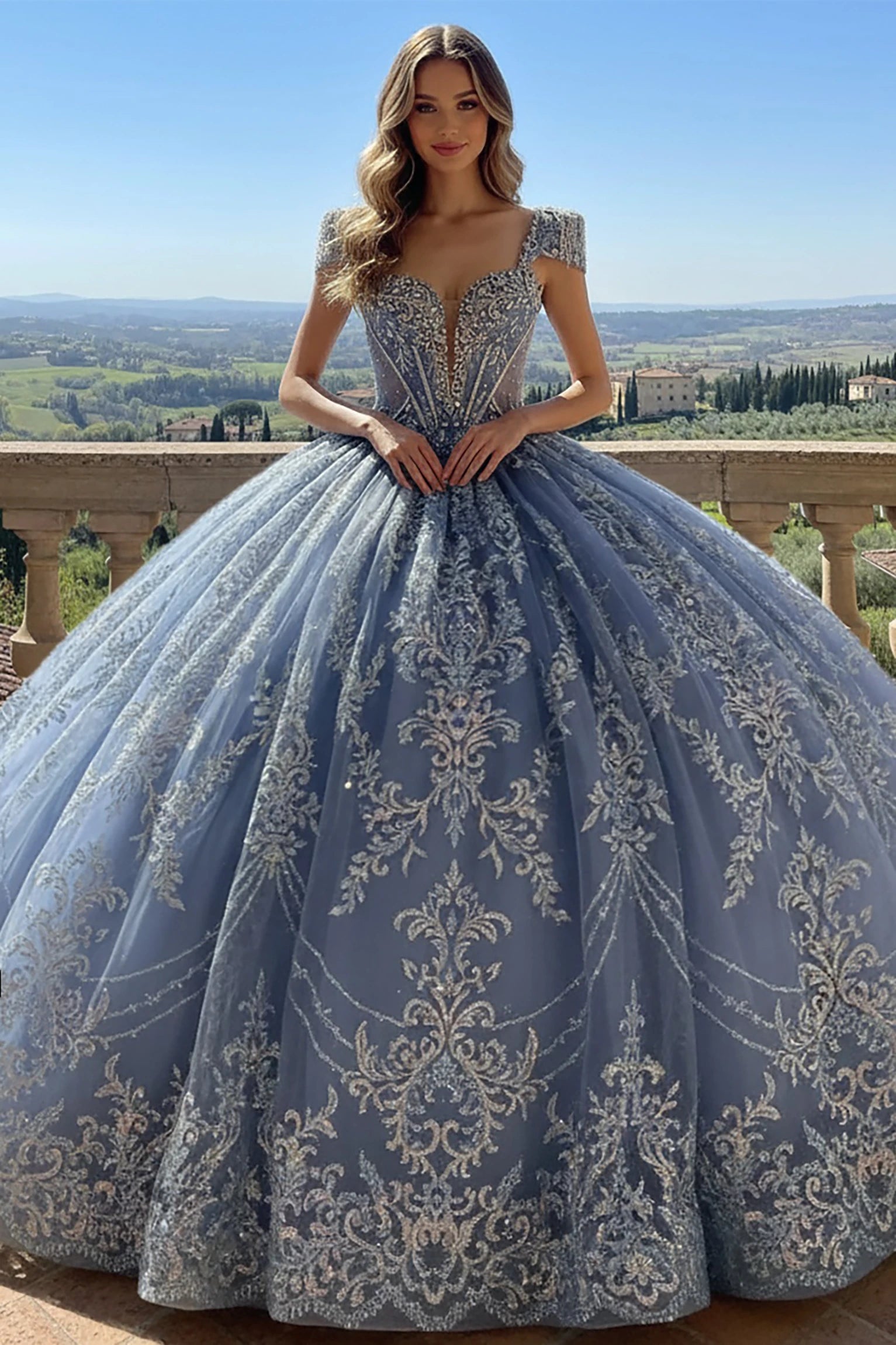 Woman wearing a blue quinceanera ball gown with beautiful silver embroidery and detachable delicate cap sleeves