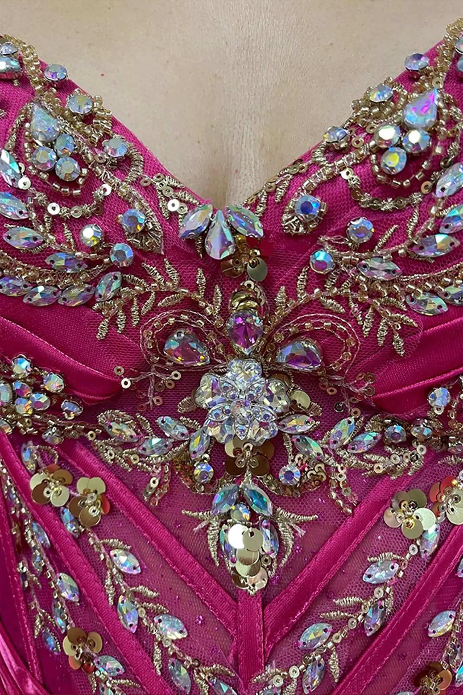 Fuchsia quinceanera ball gown showing crystal beading, rhinestones and gold embroidery