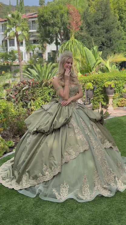 a girl wearing sage satin quince dress and tiara showing her back in a green garden. video