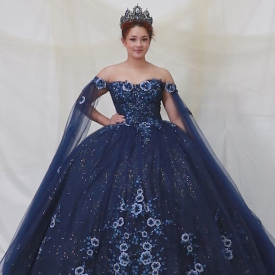 Video of Navy Quinceañera Dress with 3D Floral Applique, Detachable Sheer Cape and Glitter Tulle