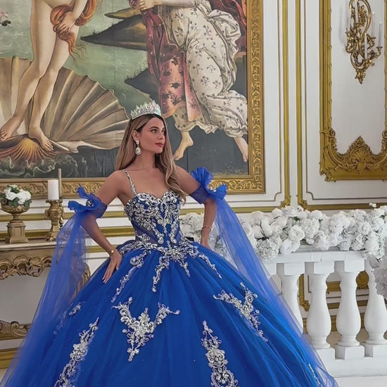 girl in a Blue ball gown with intricate silver embroidery in a decorated room. video