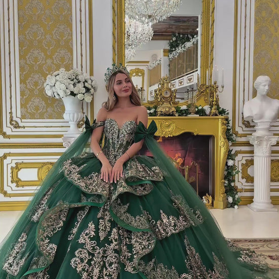 video of Woman in a green gown with gold embroidery in an ornate room.