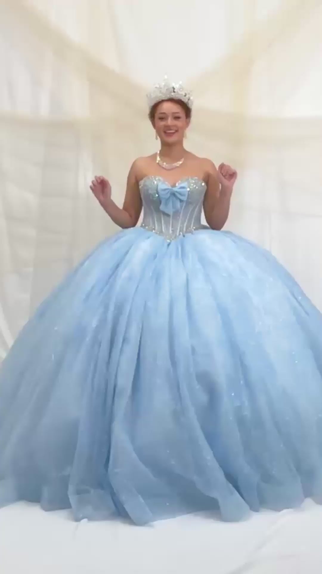 Video of Bahama Blue Quinceañera Dress with Crystal Beading, Glitter Floral Tulle and Front Bow Detail