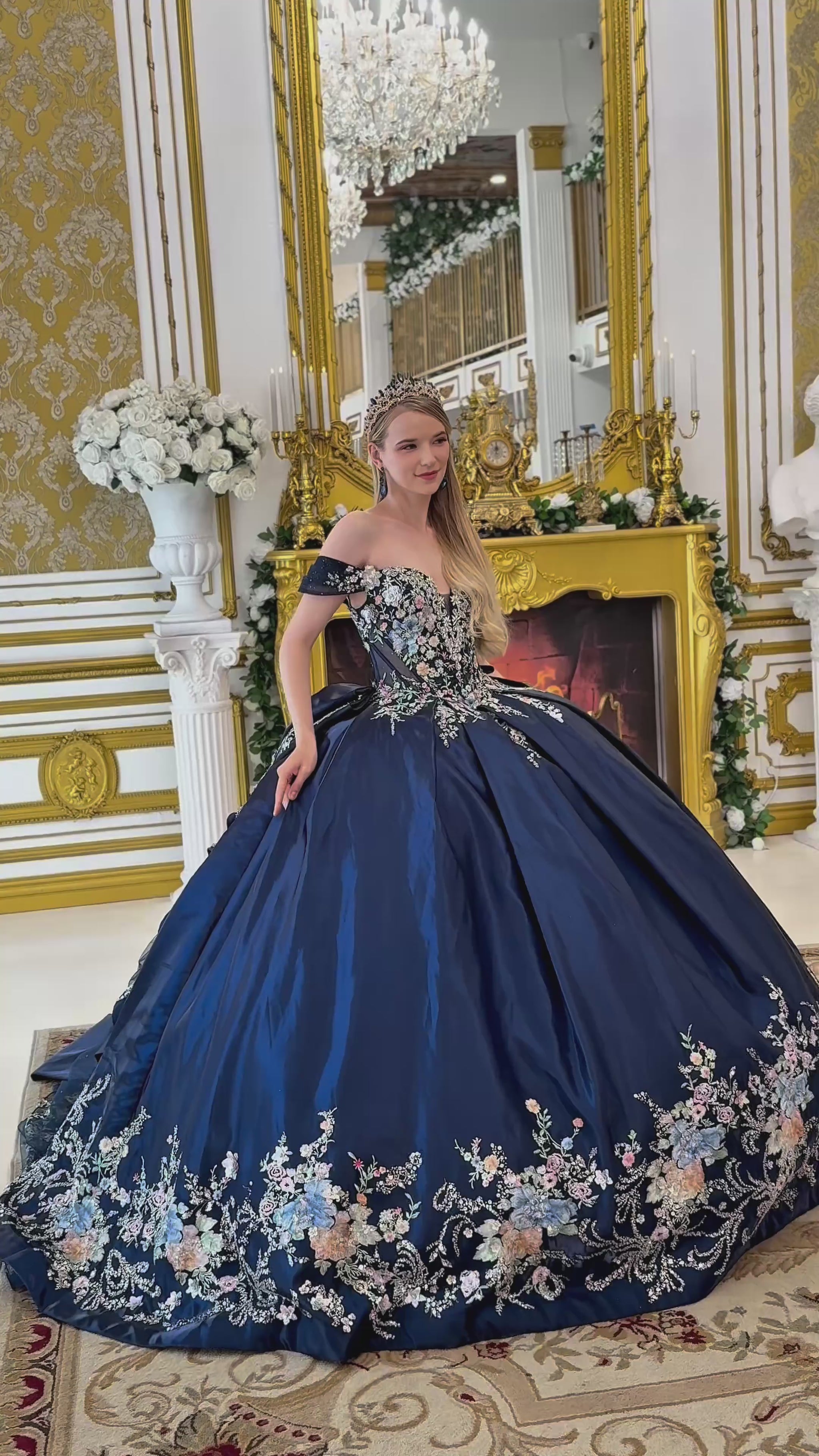 a video of navy quinceañera dress showing floral embroidery on top of the dress and the bottom of the dress