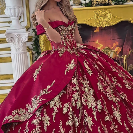 Video: a girl wearing a burgundy quinceanera dress with gold floral embroidery 