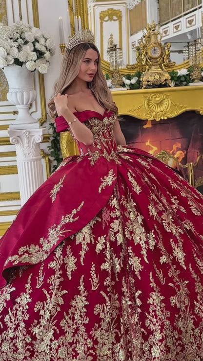 Video: a girl wearing a burgundy quinceanera dress with gold floral embroidery 
