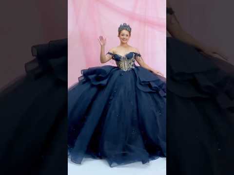 girl in the navy dress dancing and showing her long back train