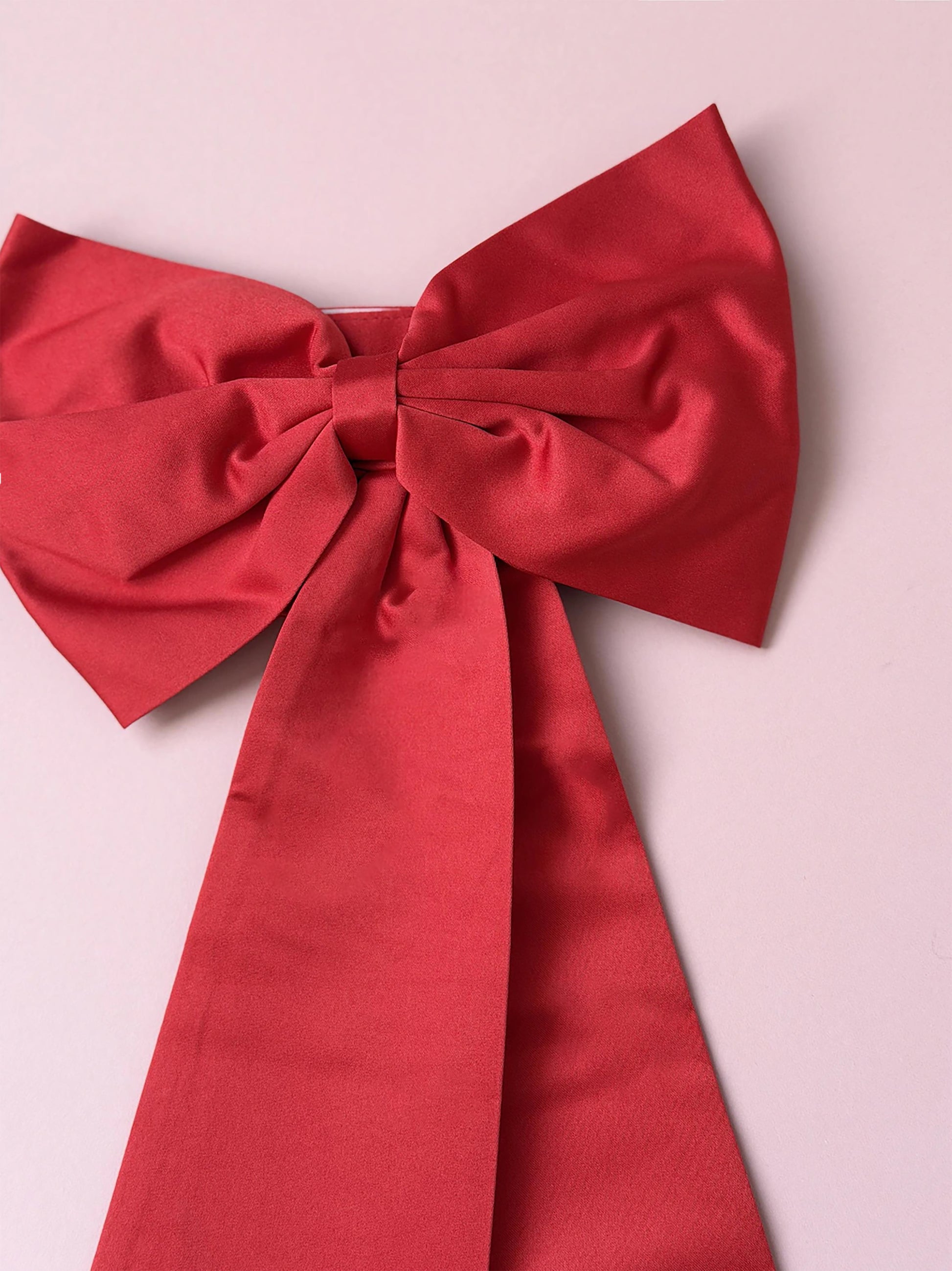 Red bow on a pink background