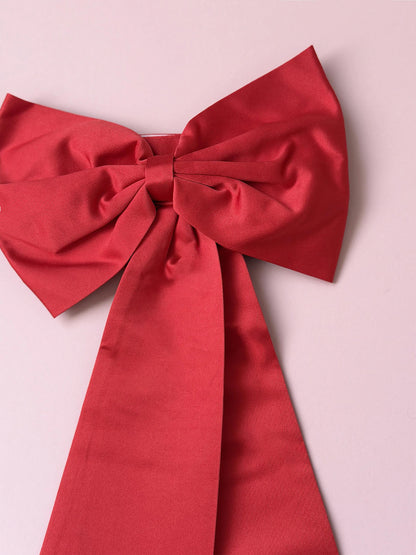 Red bow on a pink background