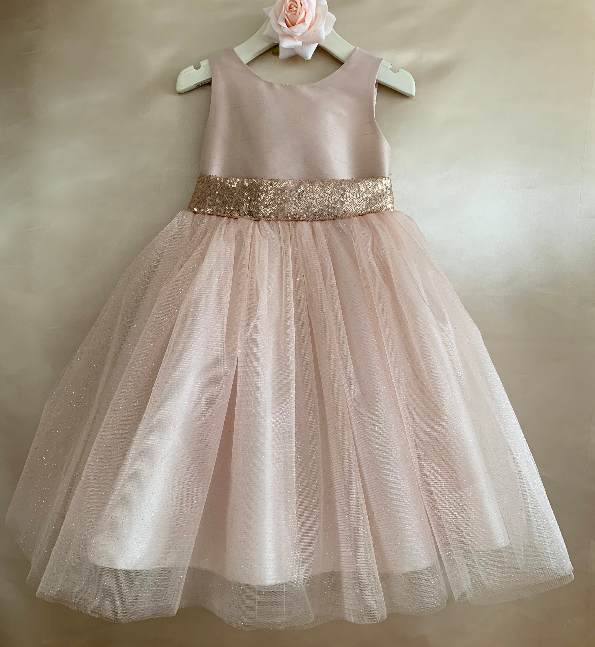 Rose Gold USA Made | Sequin V-Back Tulle Flower Girl Dress with detachable Ribbon pin - front view of dress on hanger