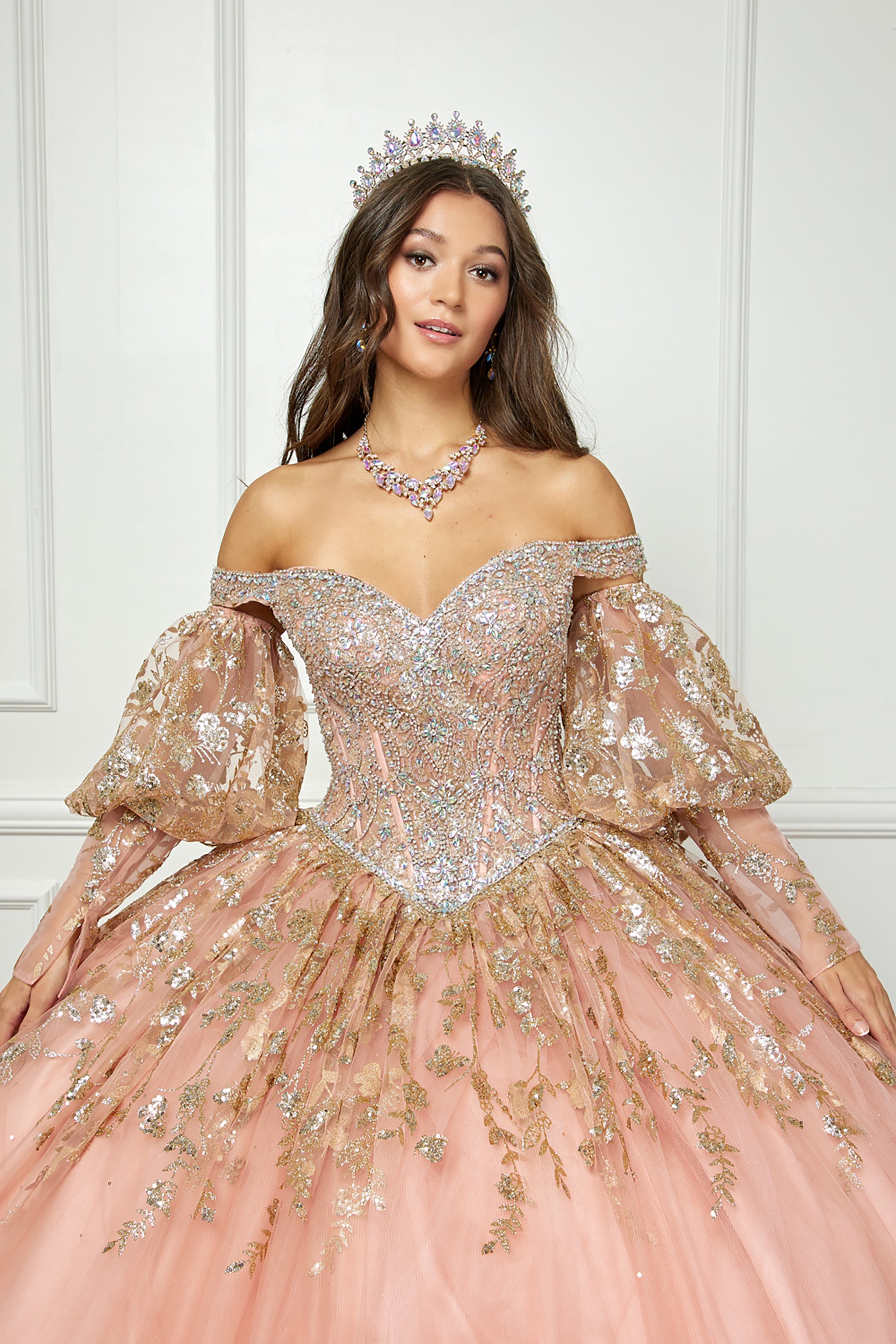 Rose Gold Detachable Train With Stones and Gems See-through Bodice Quince Ball Gown front view indoor with sleeves