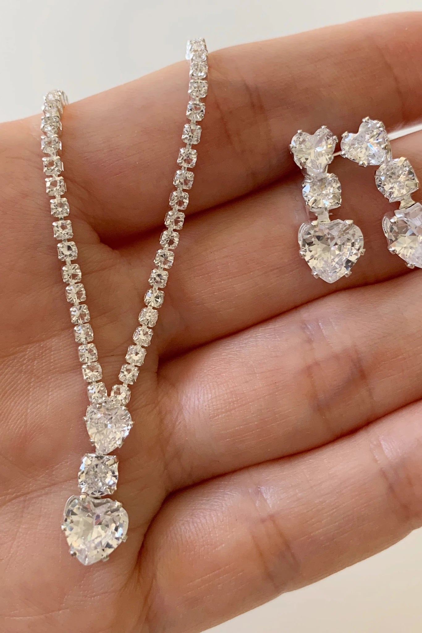 Silver rhinestone heart bridal necklace and earrings set.