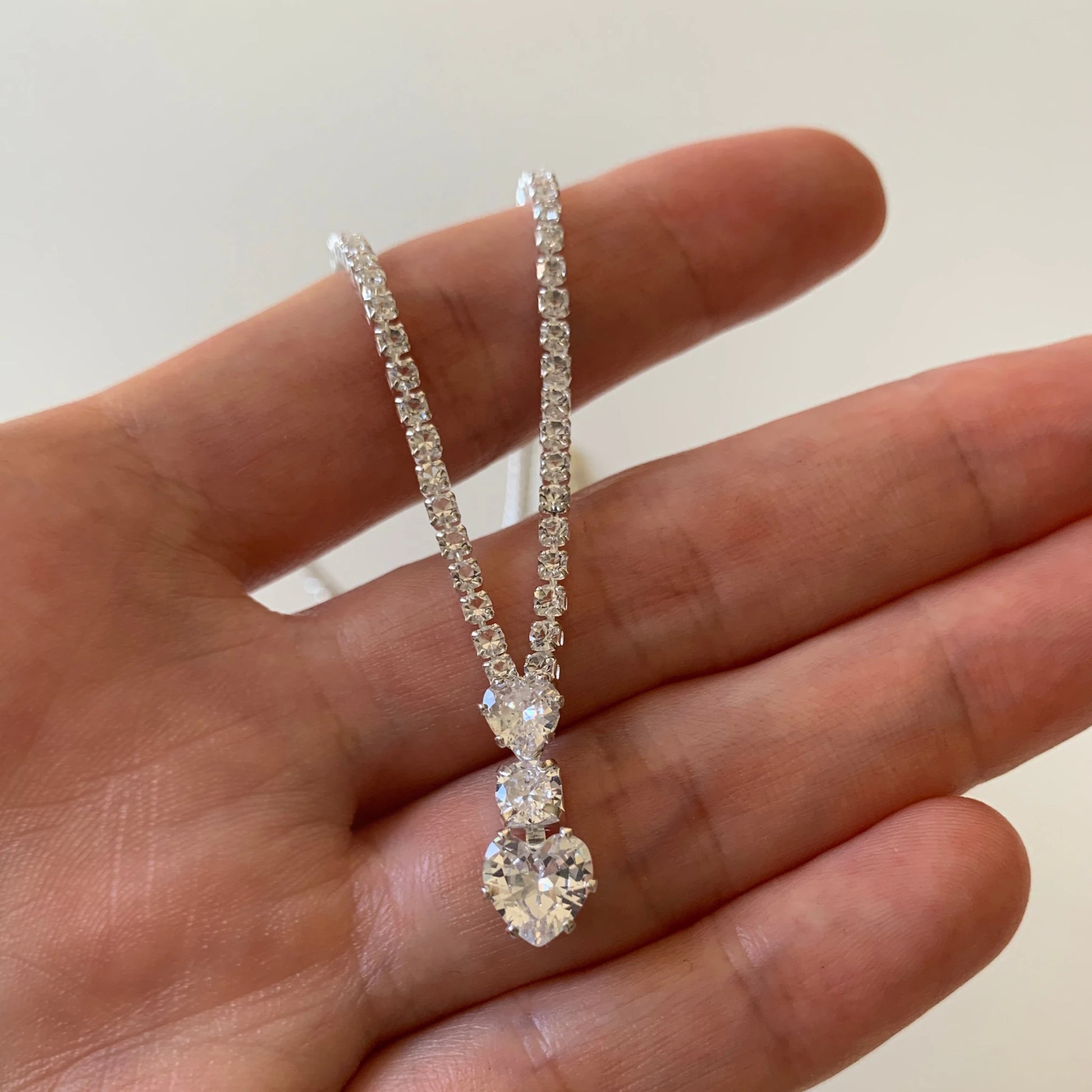 Silver rhinestone heart bridal necklace and earrings set.