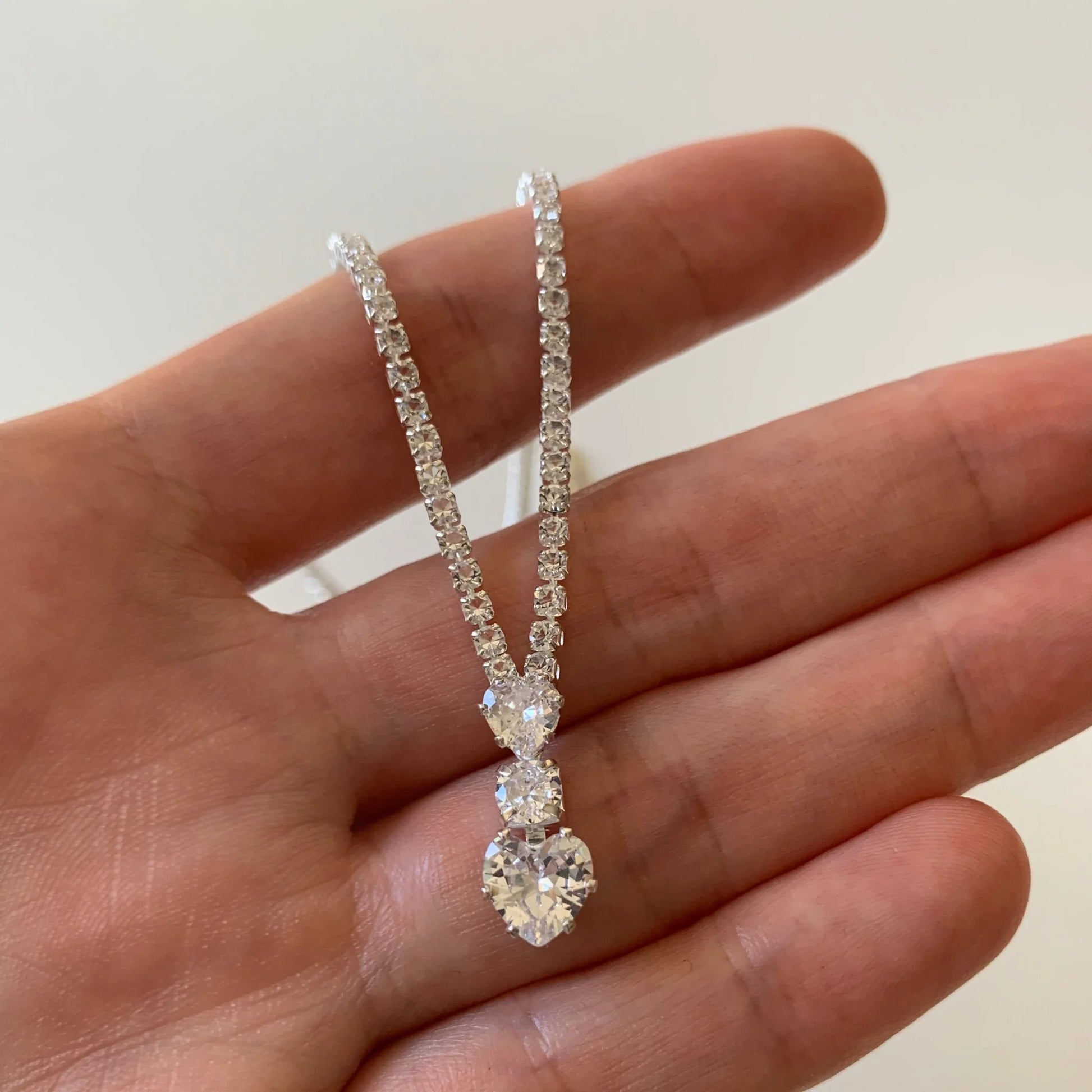 Silver rhinestone heart quinceañera and everyday women's necklace and earrings set.