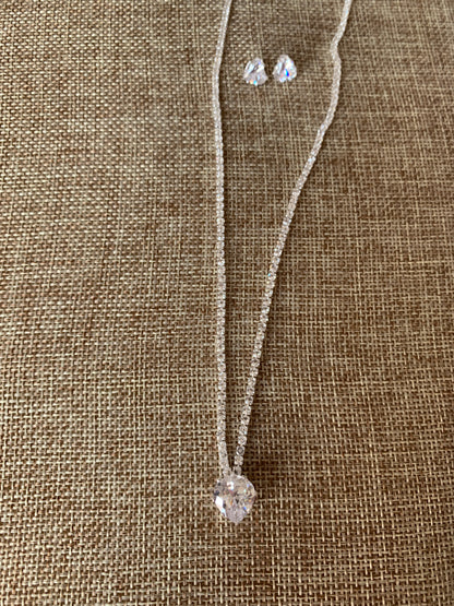 heart rhinestone necklace and earring on beige background