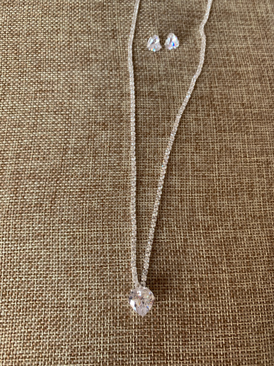 heart rhinestone necklace and earring on beige background