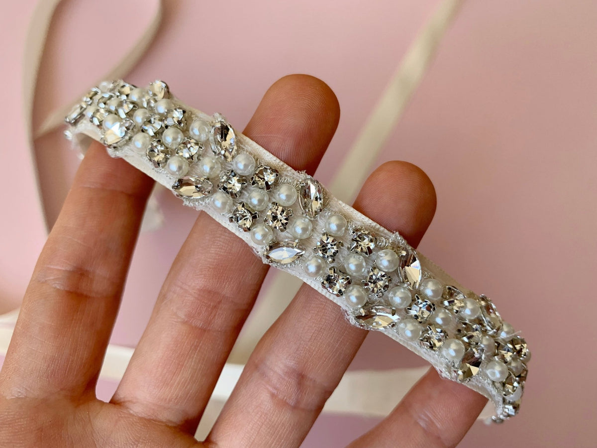 Ivory and white pearl rhinestone flower girl sash belt, close-up, embellishment detail.